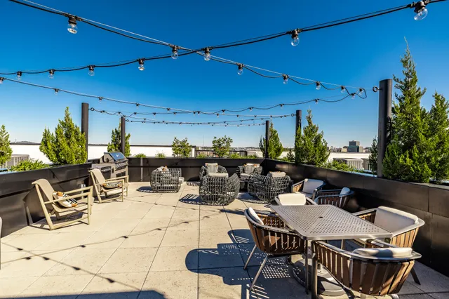 a view of a patio with a table and chairs