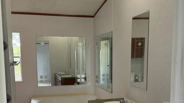 a bathroom with a glass shower door