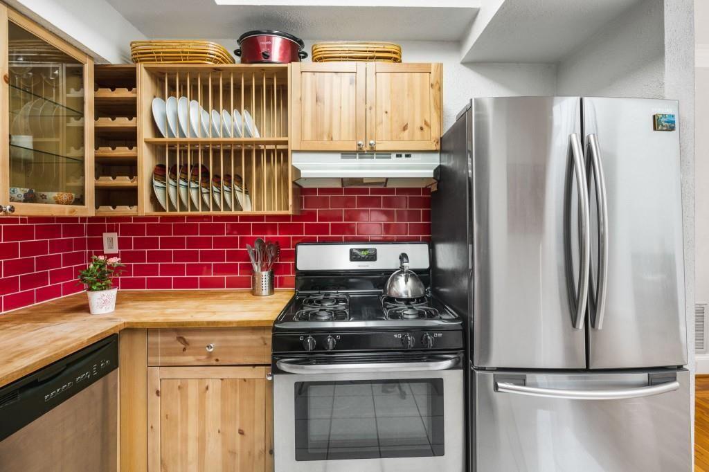 2840 Peachtree Road, Unit 503 Atlanta, GA 30305 - Photo 25 of 46 a kitchen with stainless steel appliances granite countertop a stove a refrigerator and a sink