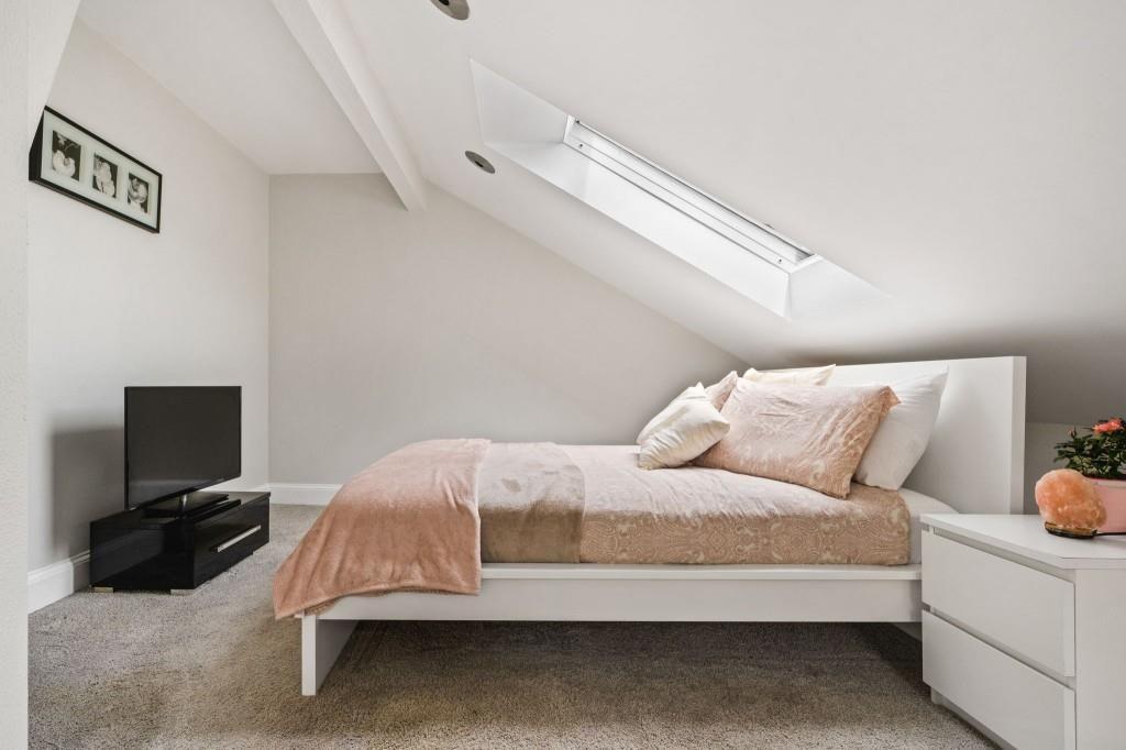 2840 Peachtree Road, Unit 503 Atlanta, GA 30305 - Photo 34 of 46 a bedroom with a bed and a flat screen tv