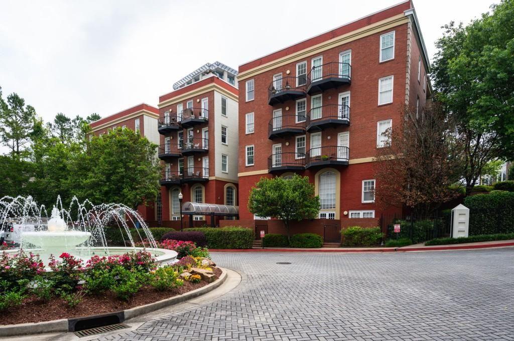 2840 Peachtree Road, Unit 503 Atlanta, GA 30305 - Photo 4 of 46 a front view of a multi story residential apartment building with yard and bench