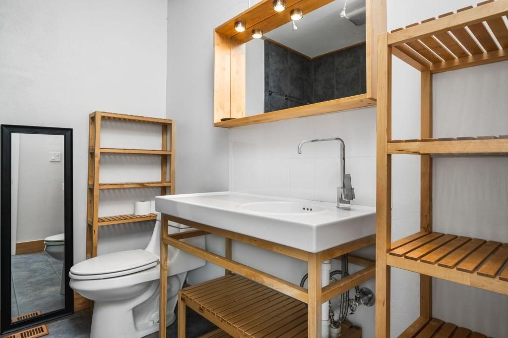 2840 Peachtree Road, Unit 503 Atlanta, GA 30305 - Photo 44 of 46 a bathroom with a sink a toilet and a mirror