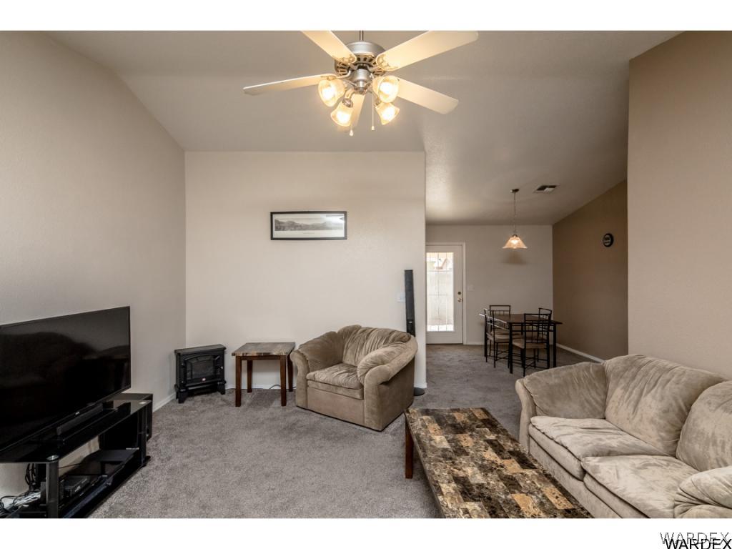 3631 North Kenneth Road Kingman, AZ 86409 - Photo 3 of 36 a living room with furniture and a flat screen tv
