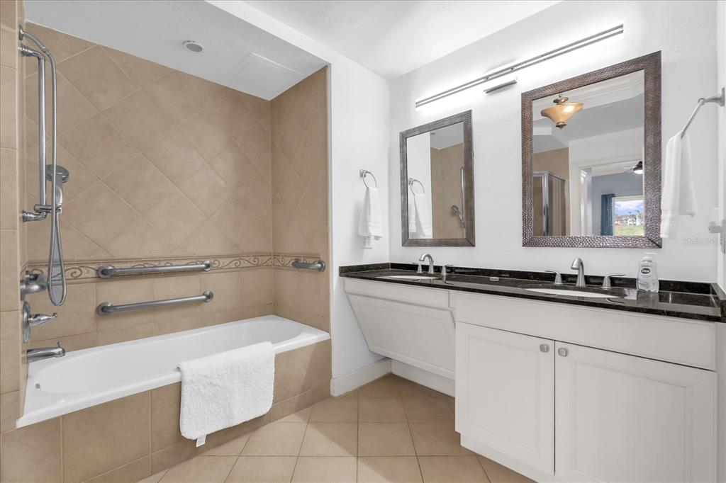 1362 Centre Ct Ridge Drive, Unit 102 Reunion, FL 34747 - Photo 13 of 35 a bathroom with a double vanity sink a mirror and a