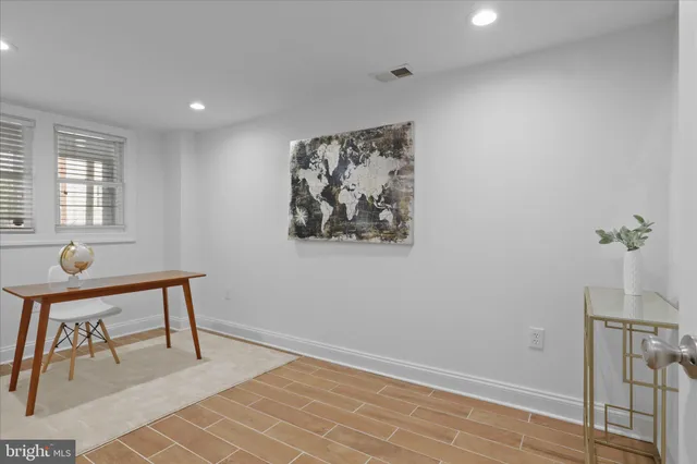 a view of a workspace with furniture and a window
