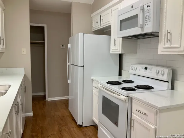 a kitchen with a stove and a refrigerator