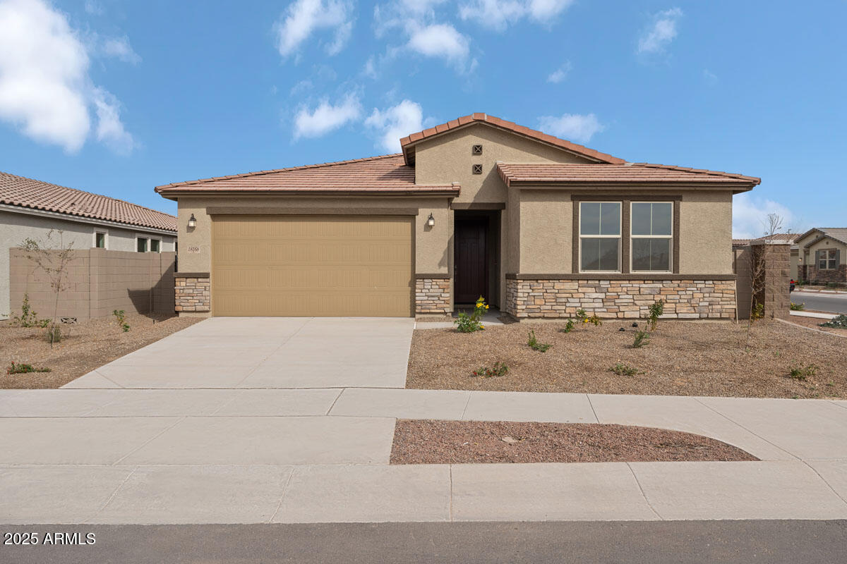 18168 West Pima Street Goodyear, AZ 85338 - Photo 1 of 21 a front view of a house with garden