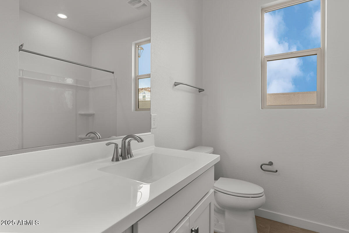 18168 West Pima Street Goodyear, AZ 85338 - Photo 17 of 21 a bathroom with a sink and a toilet