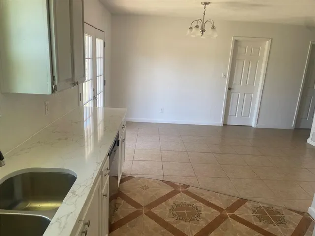 a view of a room with wooden floor and windows