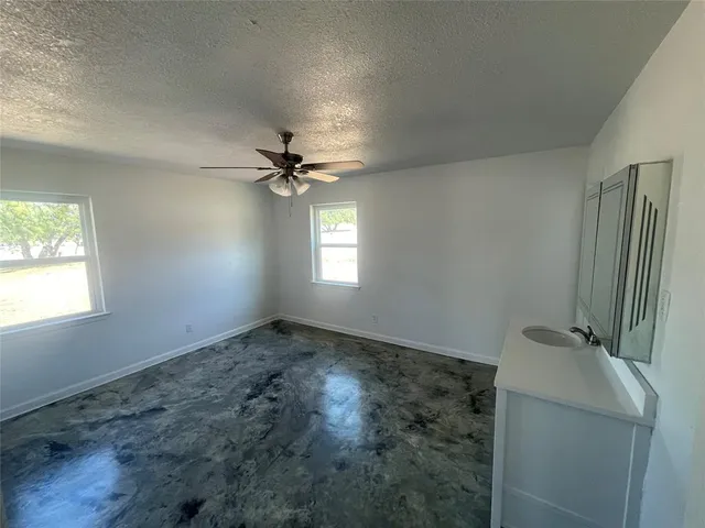 a view of a livingroom with wooden floor and a window