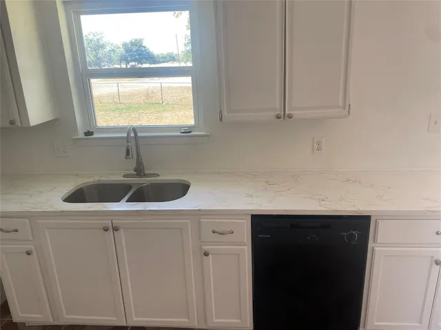 an empty room with wooden floor and closet