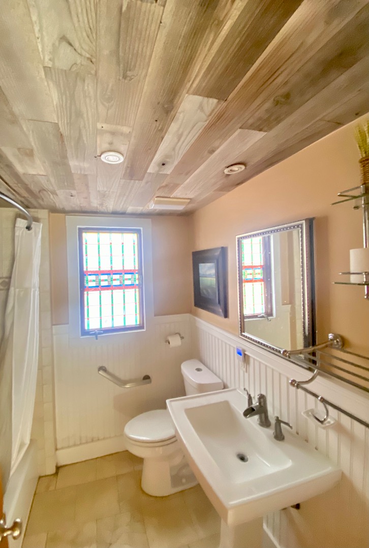 101 Tradewinds Road Oak Bluffs, MA 02557 - Photo 31 of 59 a bathroom with a sink a toilet and mirror