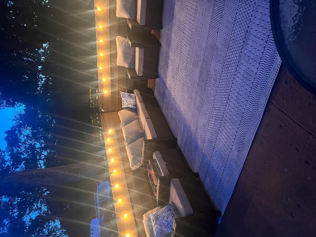 101 Tradewinds Road Oak Bluffs, MA 02557 - Photo 35 of 59 a living room with furniture and a lamp