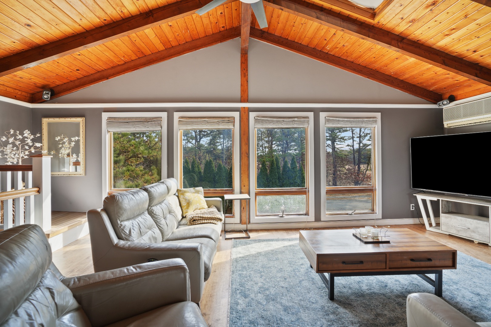 101 Tradewinds Road Oak Bluffs, MA 02557 - Photo 4 of 59 a living room with furniture a flat screen tv and large windows