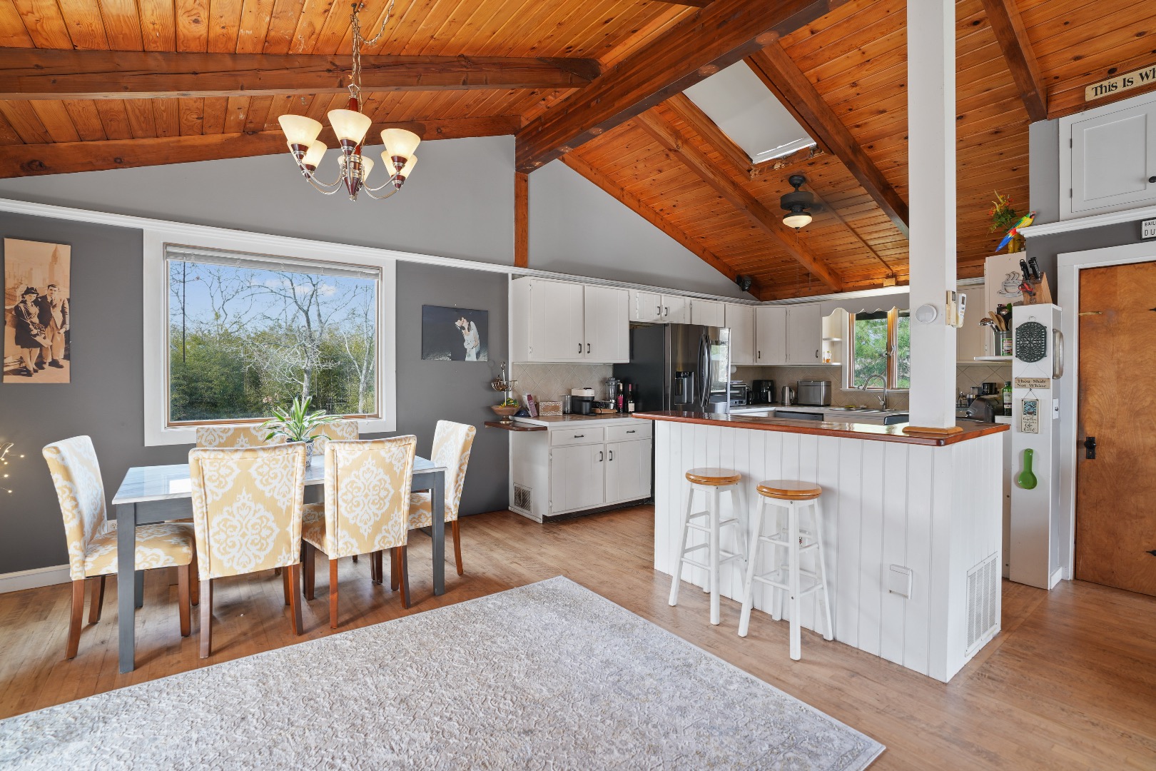 101 Tradewinds Road Oak Bluffs, MA 02557 - Photo 6 of 59 a dining room with stainless steel appliances kitchen island granite countertop a living room dining room and kitchen view