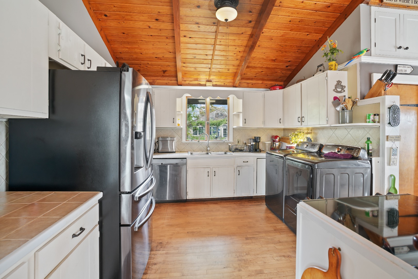 101 Tradewinds Road Oak Bluffs, MA 02557 - Photo 9 of 59 a kitchen with granite countertop a sink stainless steel appliances and cabinets