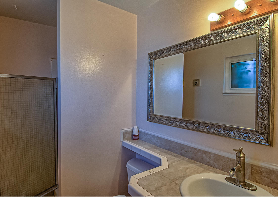 20458 Womack Road Red Bluff, CA 96080 - Photo 11 of 20 a bathroom with a granite countertop sink and a mirror