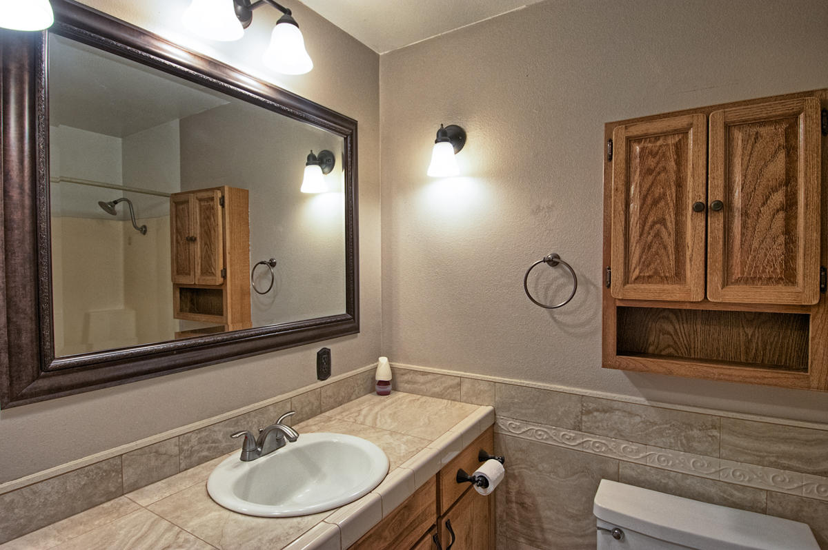 20458 Womack Road Red Bluff, CA 96080 - Photo 14 of 20 a bathroom with a sink and a mirror