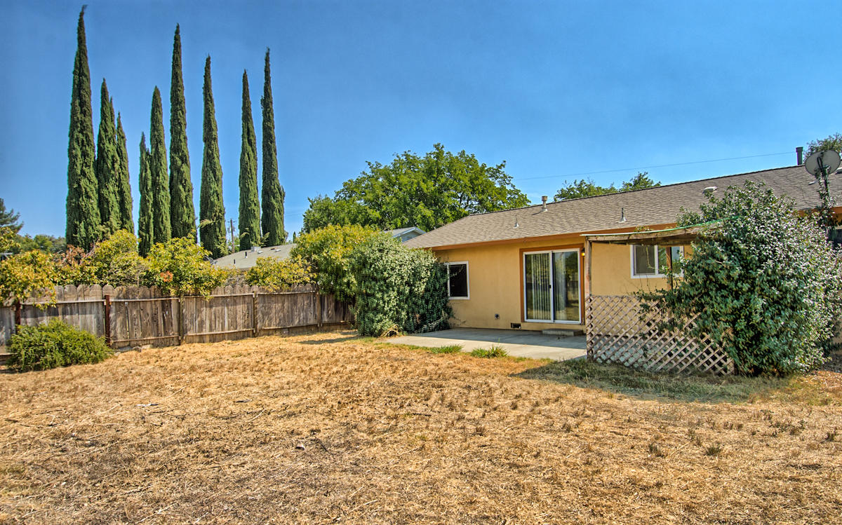 20458 Womack Road Red Bluff, CA 96080 - Photo 18 of 20 a view of a house with a backyard and trees