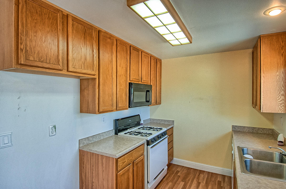 20458 Womack Road Red Bluff, CA 96080 - Photo 7 of 20 a kitchen with stainless steel appliances granite countertop a sink stove and refrigerator