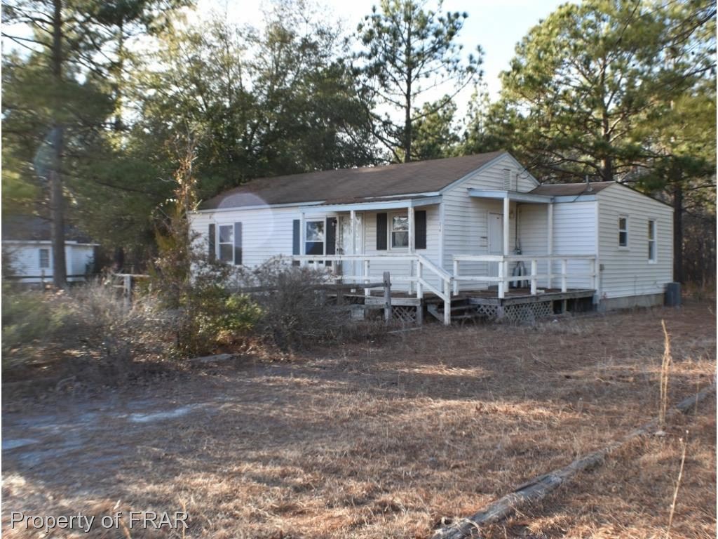 216 R Sands Road Carthage, NC 28327 - Photo 1 of 28 a front view of a house with a yard and trees
