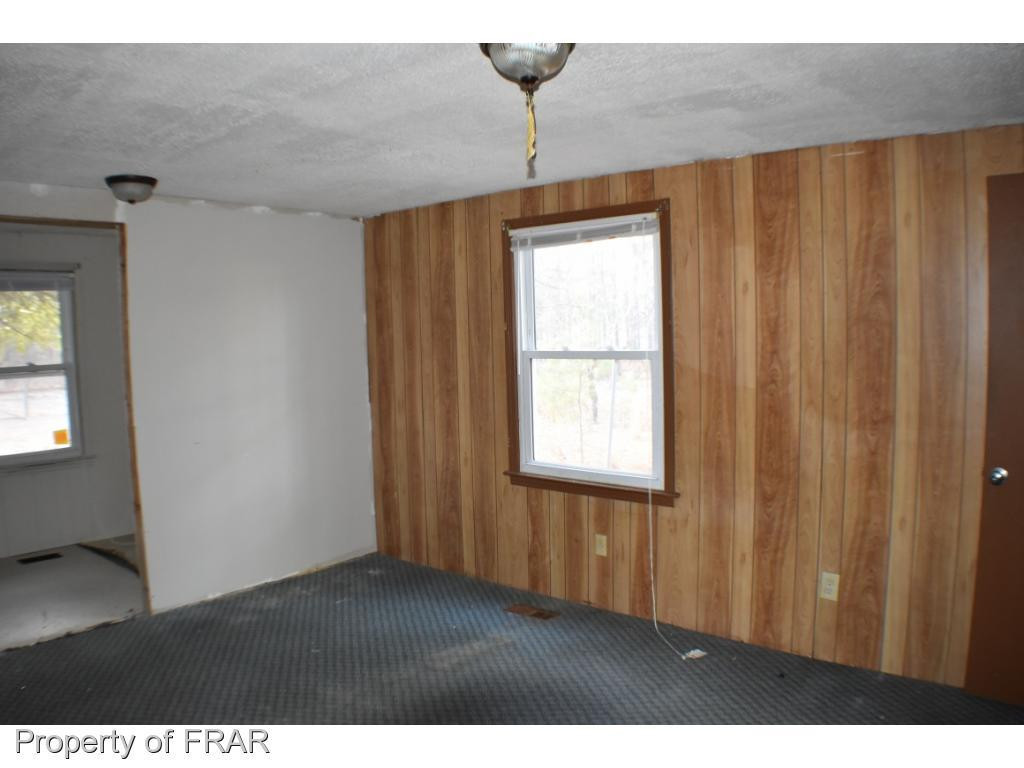 216 R Sands Road Carthage, NC 28327 - Photo 17 of 28 a view of an empty room with a window