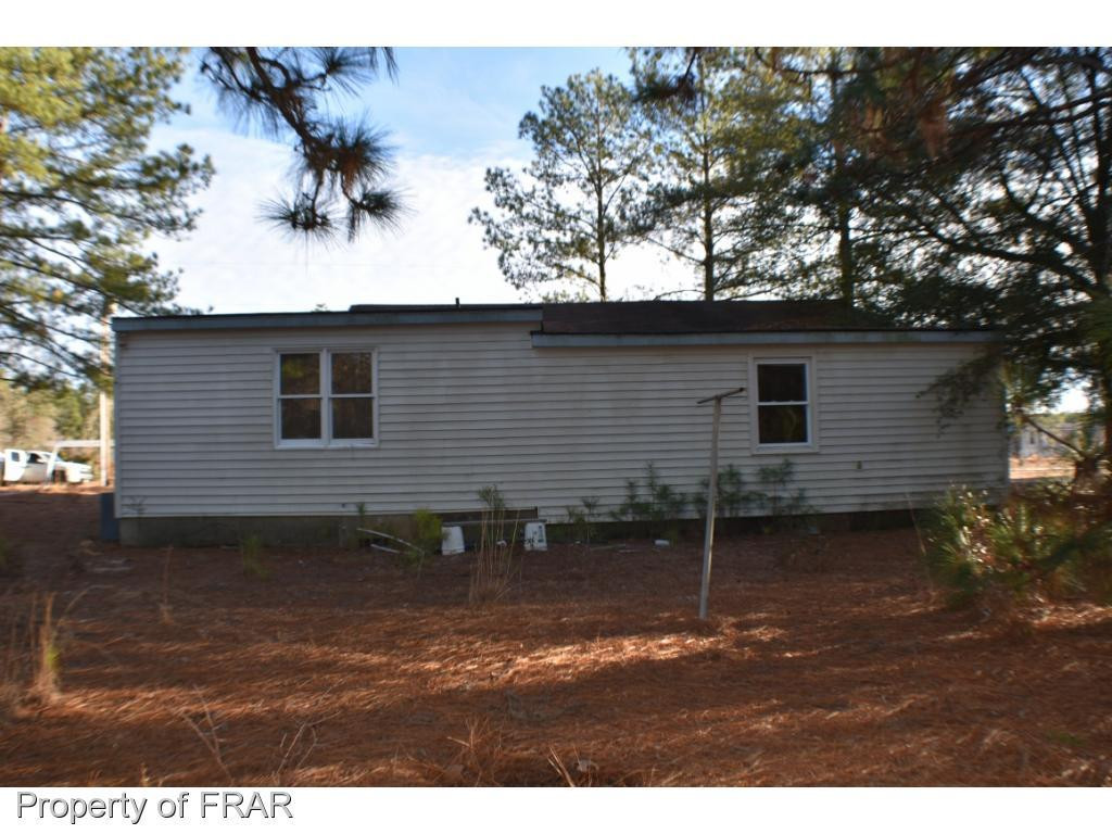216 R Sands Road Carthage, NC 28327 - Photo 25 of 28 a backyard of a house with table and chairs