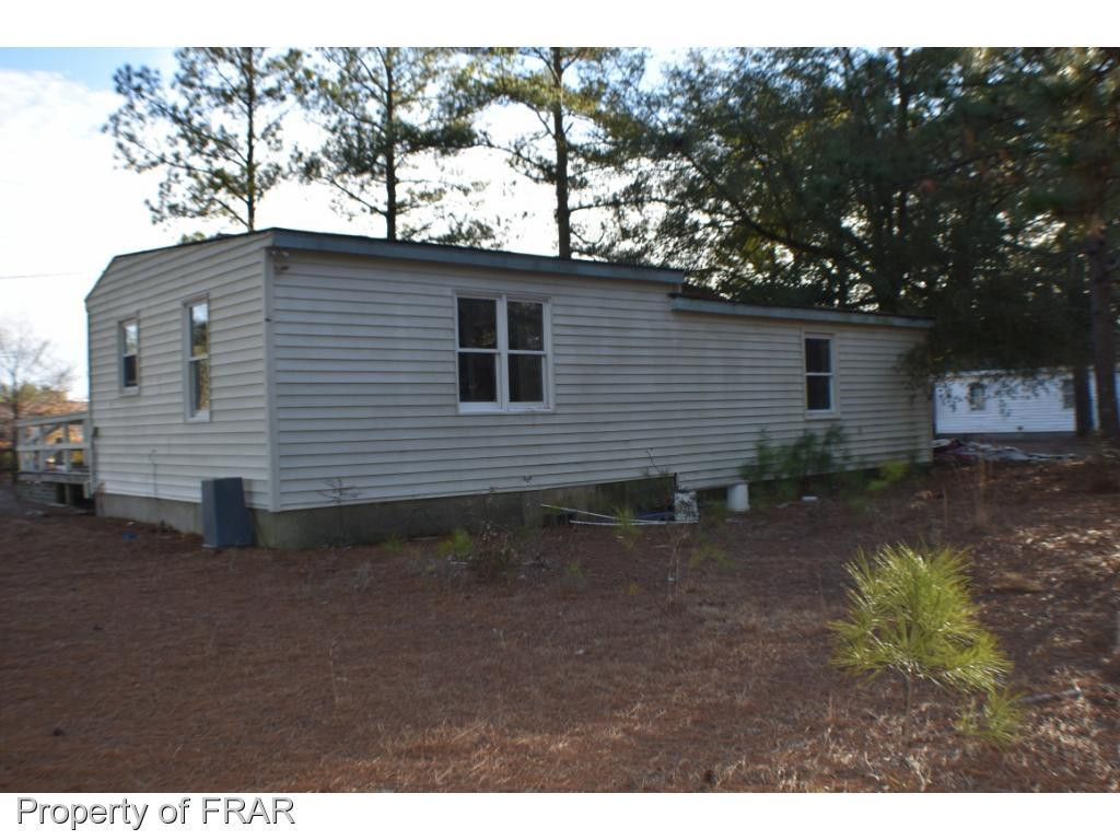 216 R Sands Road Carthage, NC 28327 - Photo 26 of 28 a backyard of a house with plants and trees