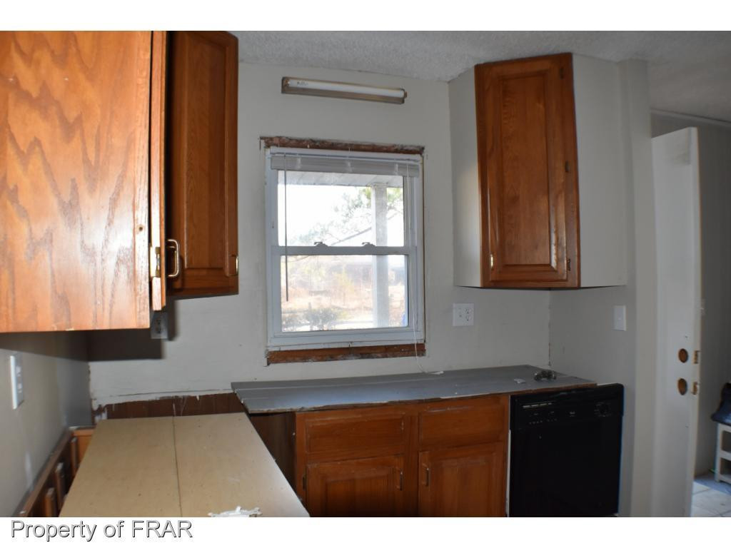 216 R Sands Road Carthage, NC 28327 - Photo 6 of 28 a kitchen view with wooden floor and window