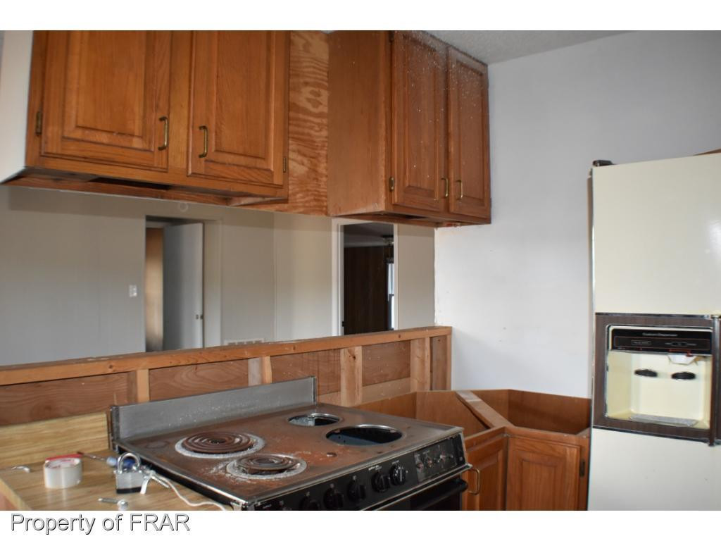 216 R Sands Road Carthage, NC 28327 - Photo 7 of 28 a black and white kitchen with stainless steel appliances