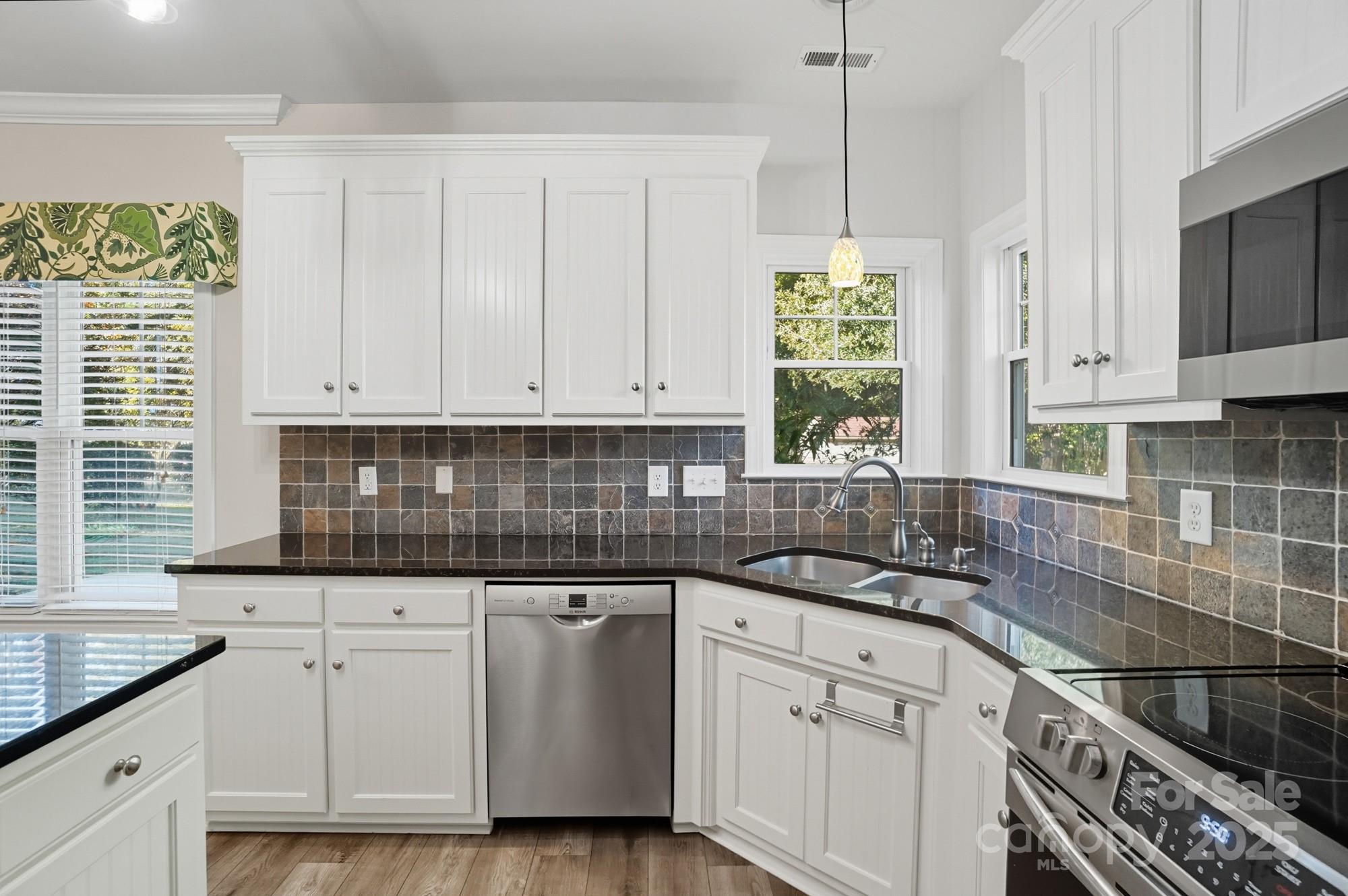 3633 Creek Ridge Drive Denver, NC 28037 - Photo 16 of 47 a kitchen with granite countertop white cabinets white appliances and a granite counter tops
