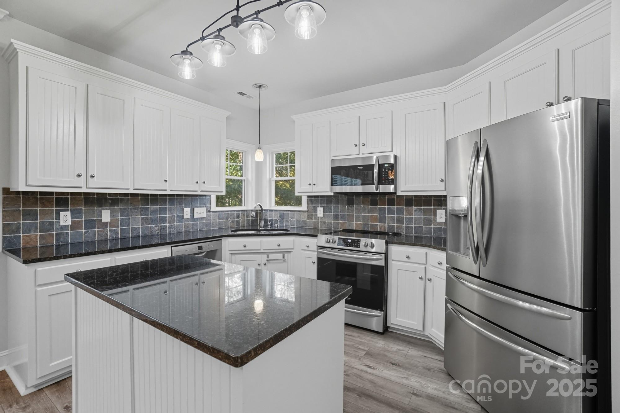 3633 Creek Ridge Drive Denver, NC 28037 - Photo 17 of 47 a kitchen with stainless steel appliances granite countertop a sink stove and refrigerator