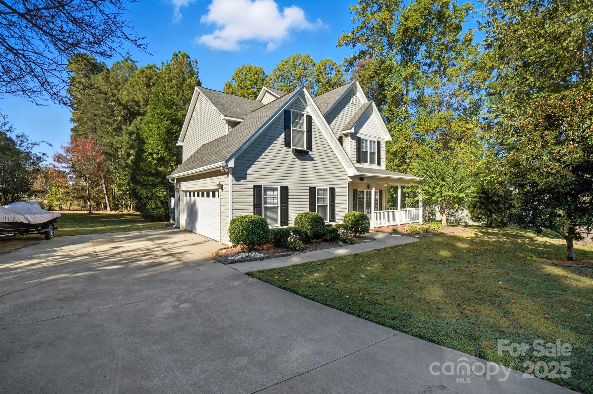 3633 Creek Ridge Drive Denver, NC 28037 - Photo 2 of 47 a front view of a house with a garden