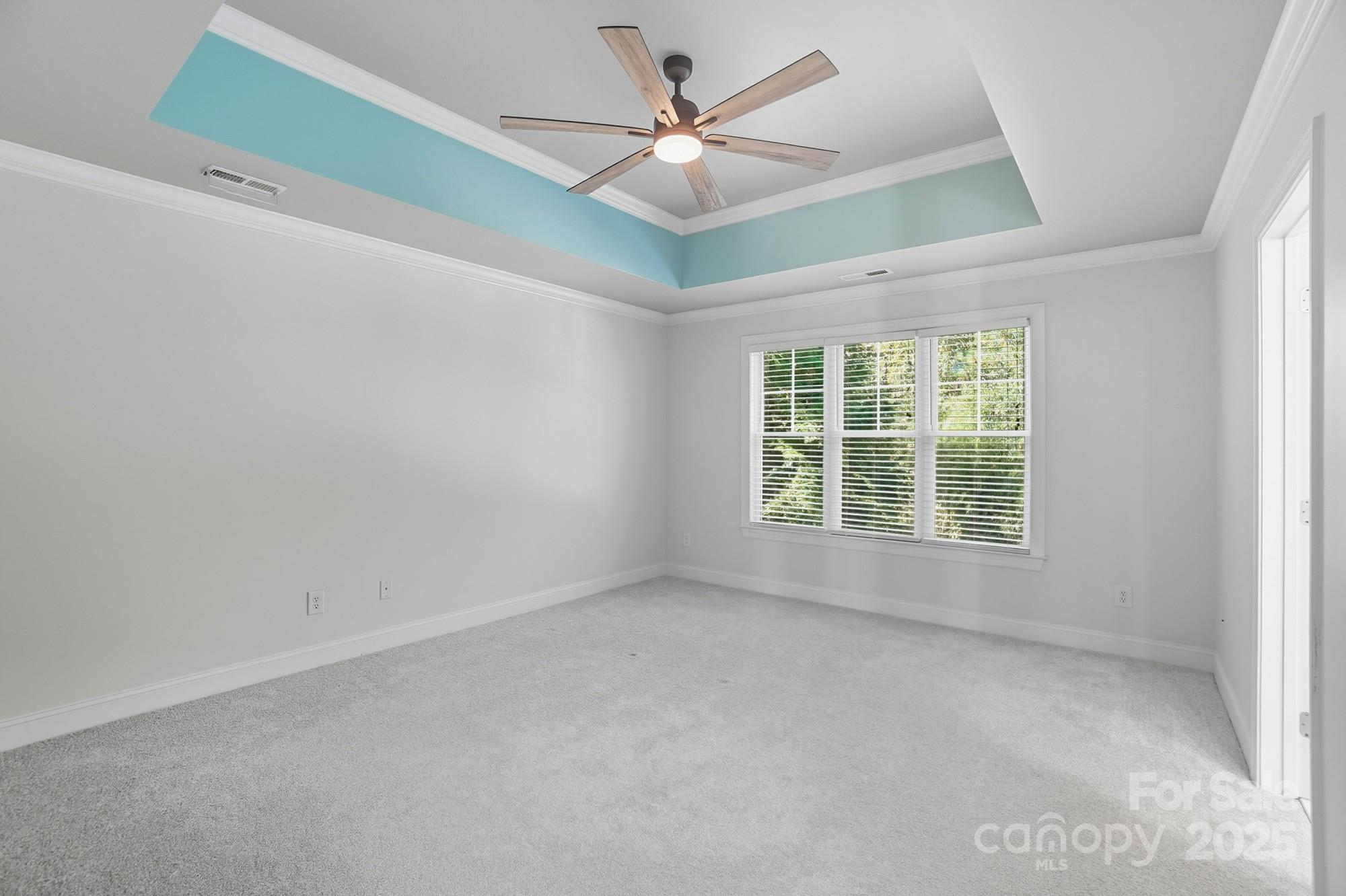 3633 Creek Ridge Drive Denver, NC 28037 - Photo 23 of 47 an empty room with a chandelier fan and windows