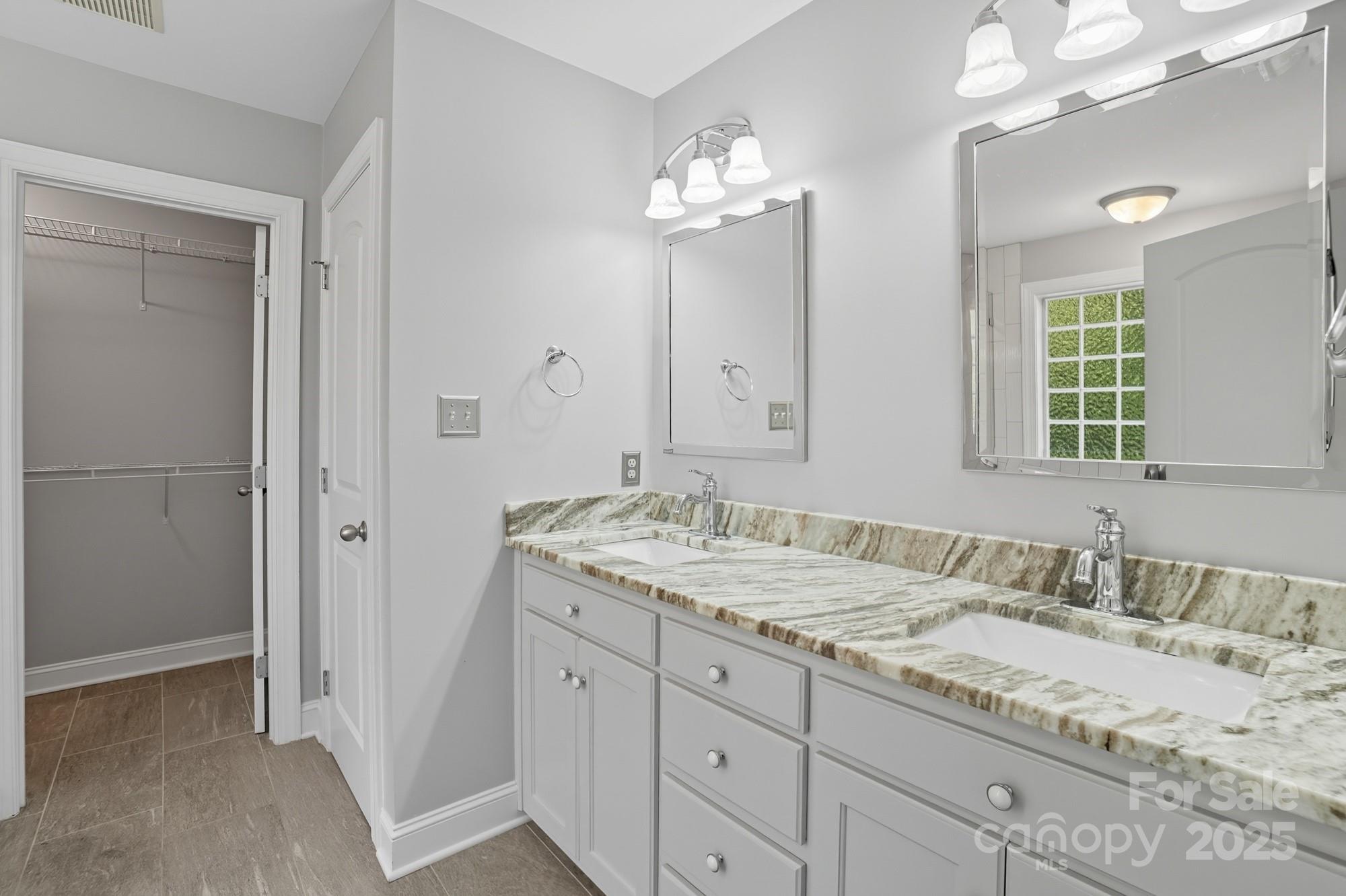 3633 Creek Ridge Drive Denver, NC 28037 - Photo 27 of 47 a bathroom with a granite countertop sink a mirror and a shower