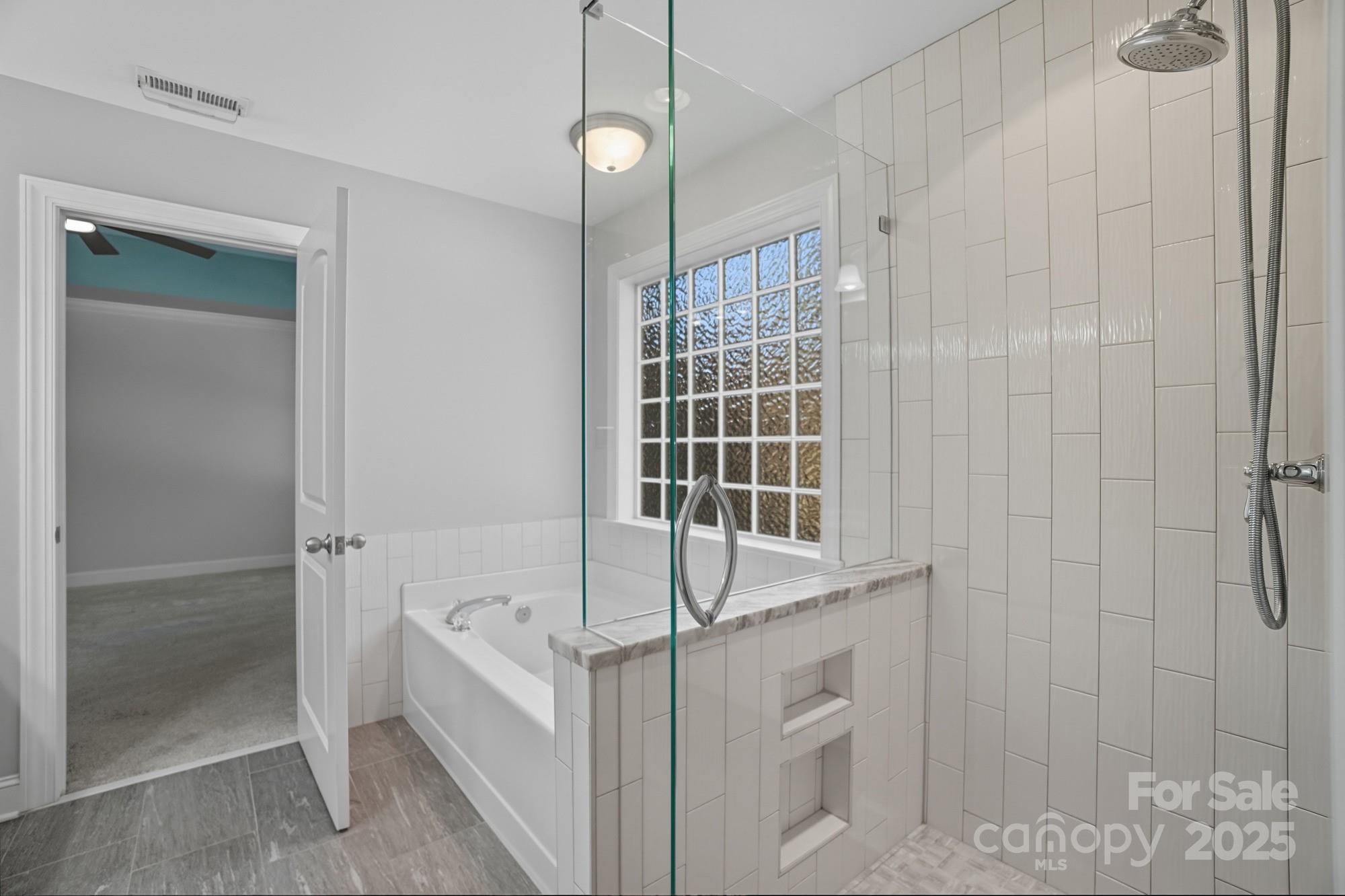 3633 Creek Ridge Drive Denver, NC 28037 - Photo 29 of 47 a bathroom with a bathtub and a shower