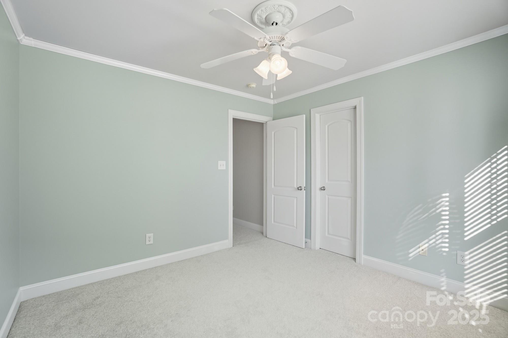 3633 Creek Ridge Drive Denver, NC 28037 - Photo 42 of 47 an empty room with a chandelier fan and windows