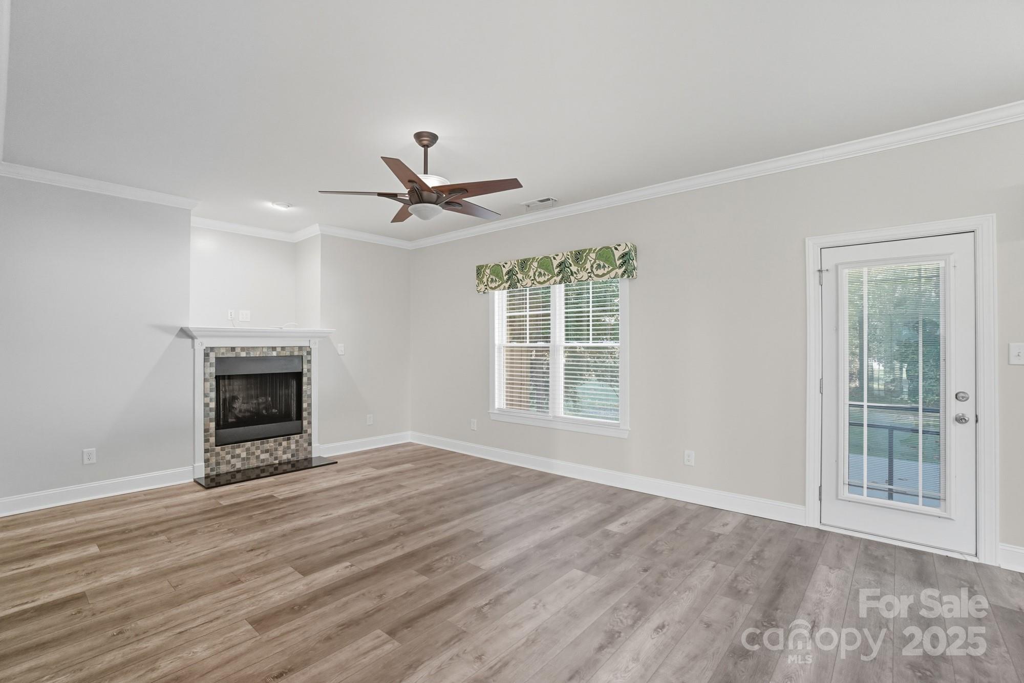 3633 Creek Ridge Drive Denver, NC 28037 - Photo 9 of 47 a view of an empty room with a window and fireplace