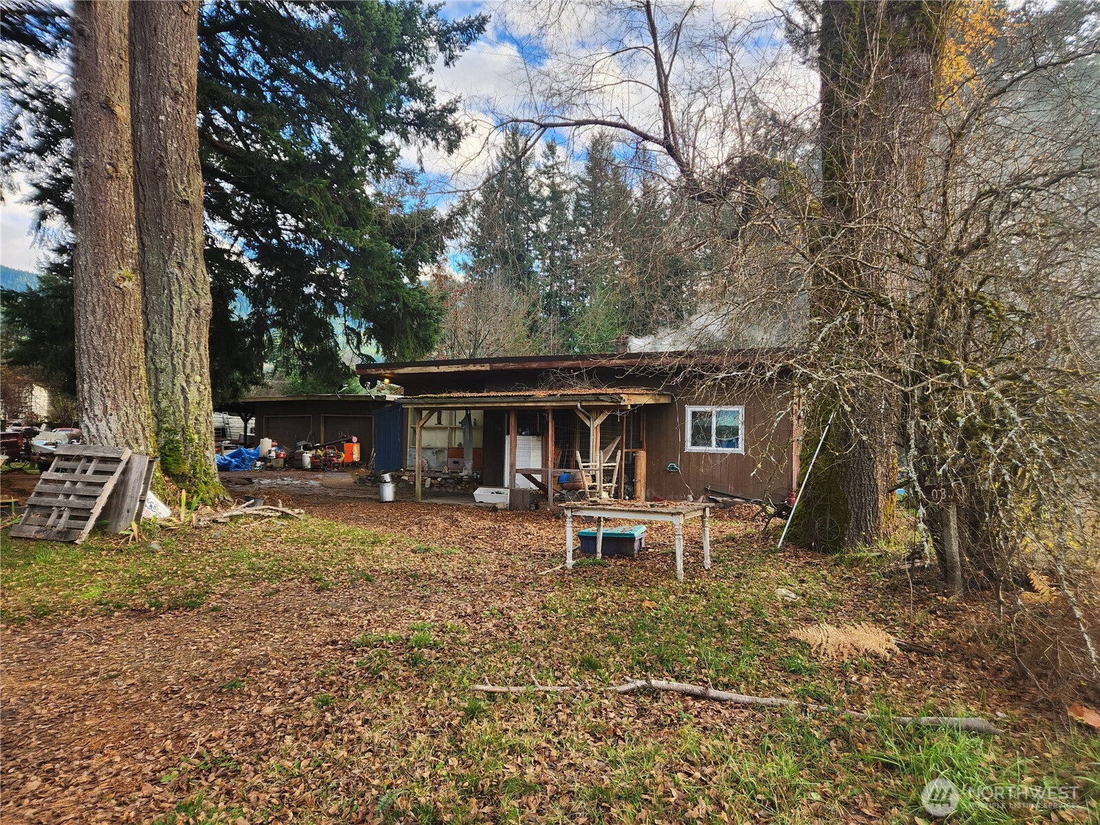 a view of a house with a yard and sitting area