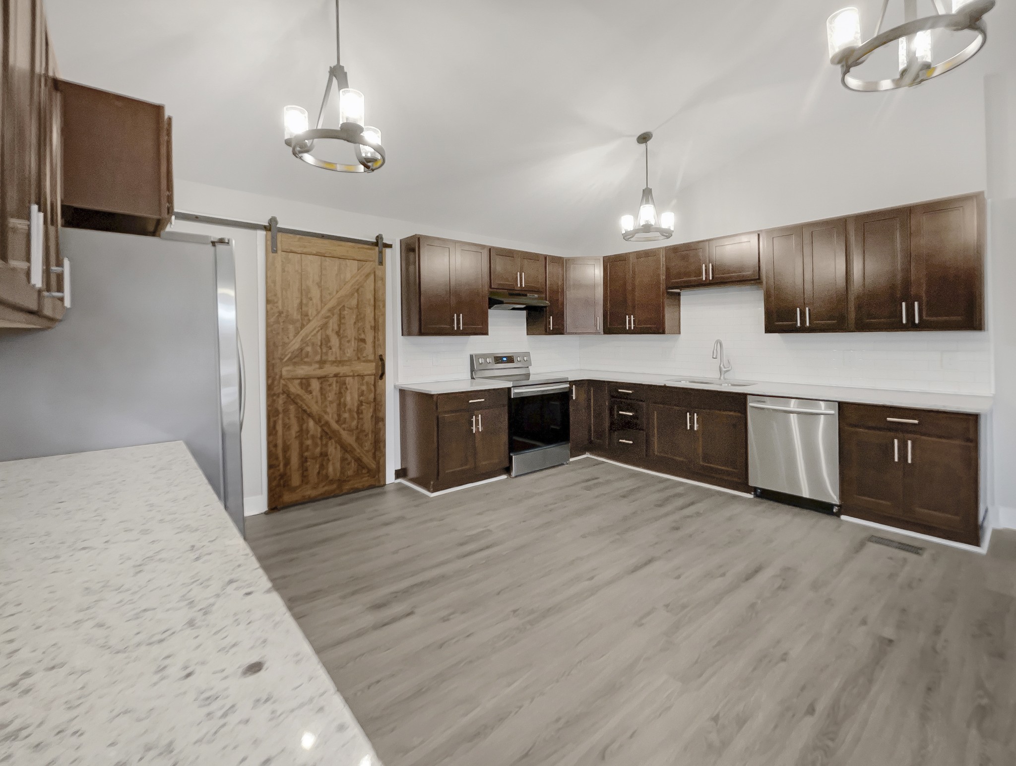 310 Tom Link Road Cottontown, TN 37048 - Photo 8 of 44 a large kitchen with cabinets a sink and stainless steel appliances