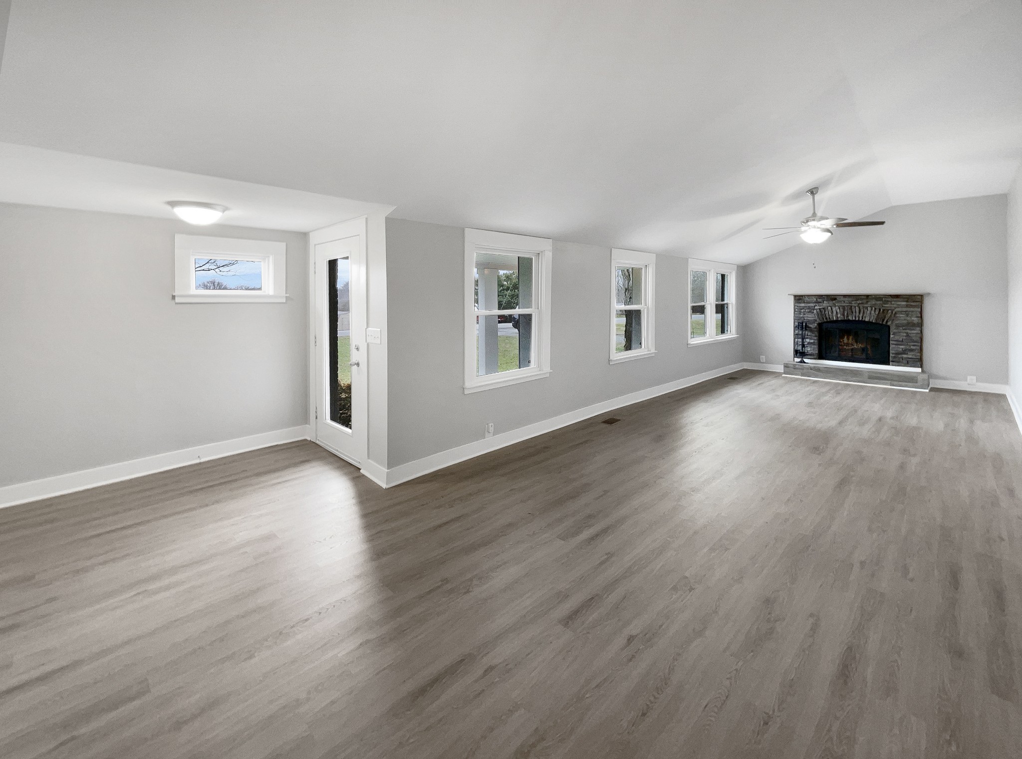310 Tom Link Road Cottontown, TN 37048 - Photo 9 of 44 an empty room with wooden floor and fireplace