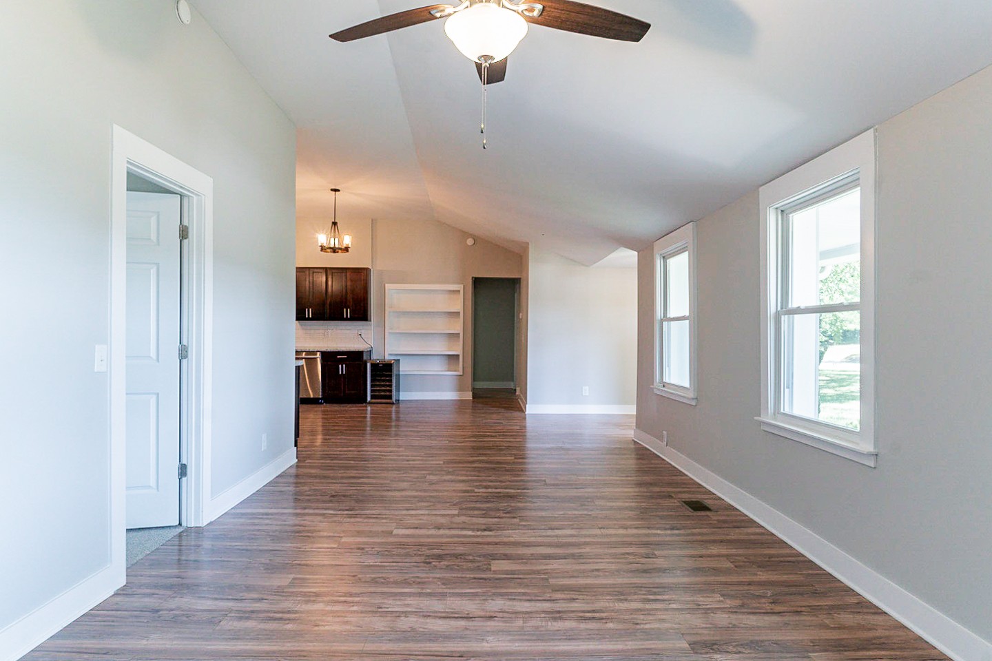 310 Tom Link Road Cottontown, TN 37048 - Photo 10 of 44 an empty room with wooden floor cabinet and windows