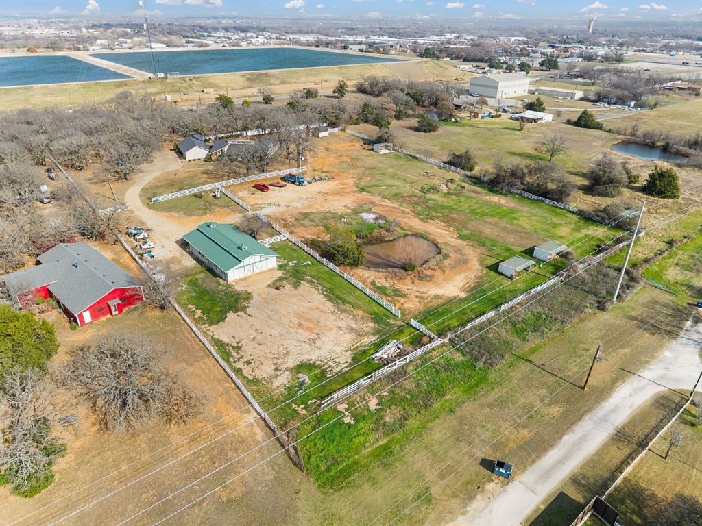 7260 Hudson Cemetery Road Mansfield, TX 76063 - Photo 40 of 40 Expansive property featuring a red barn, a large white building with a green roof, multiple sheds, and two ponds