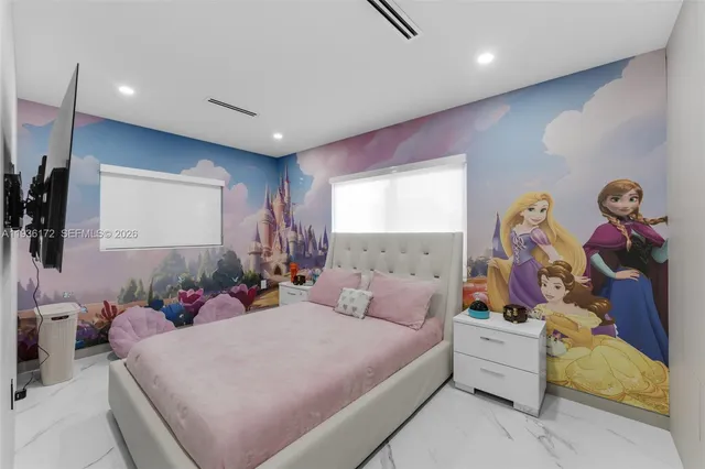 a bedroom with a bed and a flat screen tv