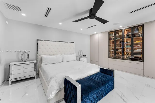 a spacious bedroom with a bed and a couch