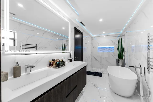a bathroom with a bathtub and a shower