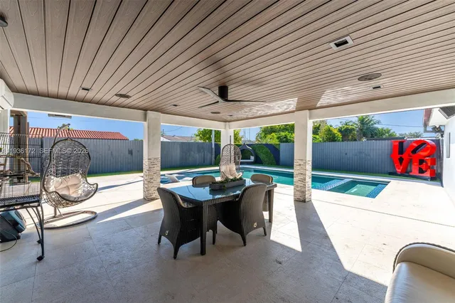 a view of a house with backyard porch and sitting area