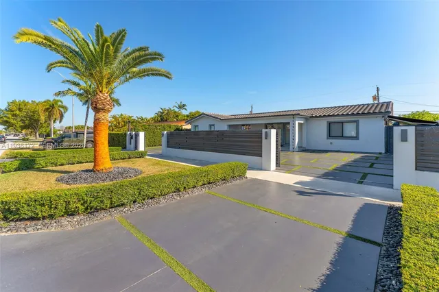 a house with palm tree in front of it
