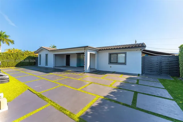 a house with swimming pool in front of it