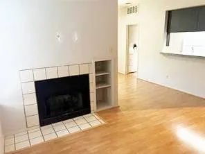 a living room with a fireplace and a flat screen tv